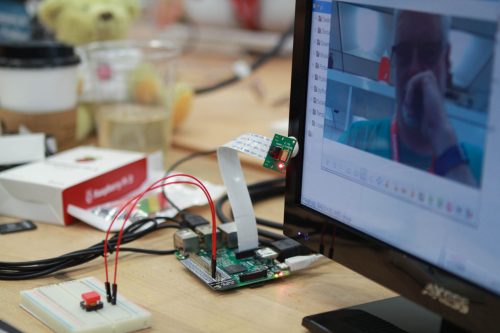 A Raspberry Pi and button attached to a computer display