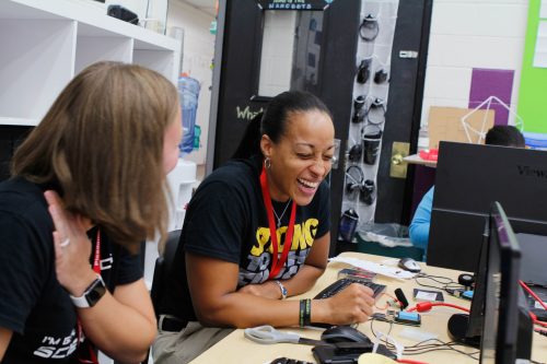 A teacher attending Picademy teacher training laughs as she works through an activity.