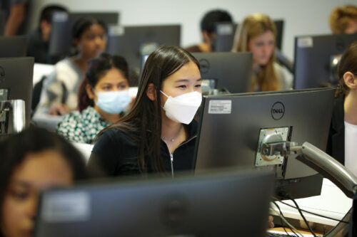 A girl in a university computing classroom.